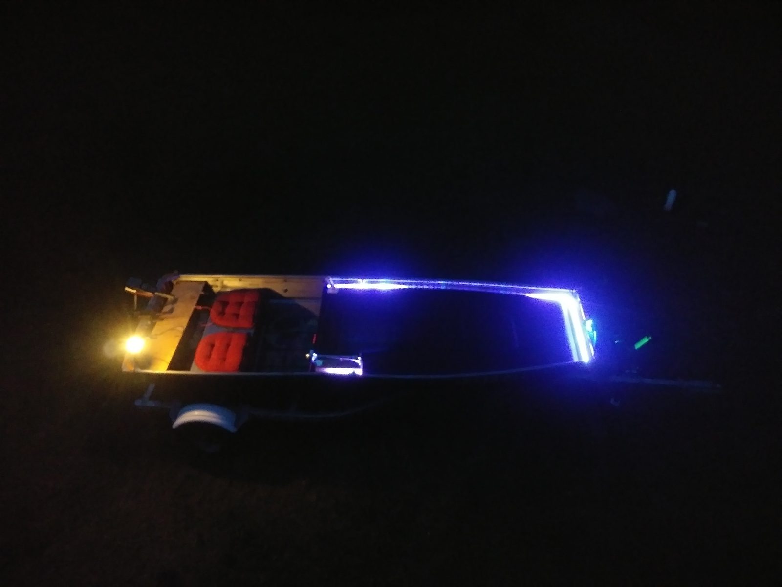 Night shot of blue LED strip lighting up the boat's frame